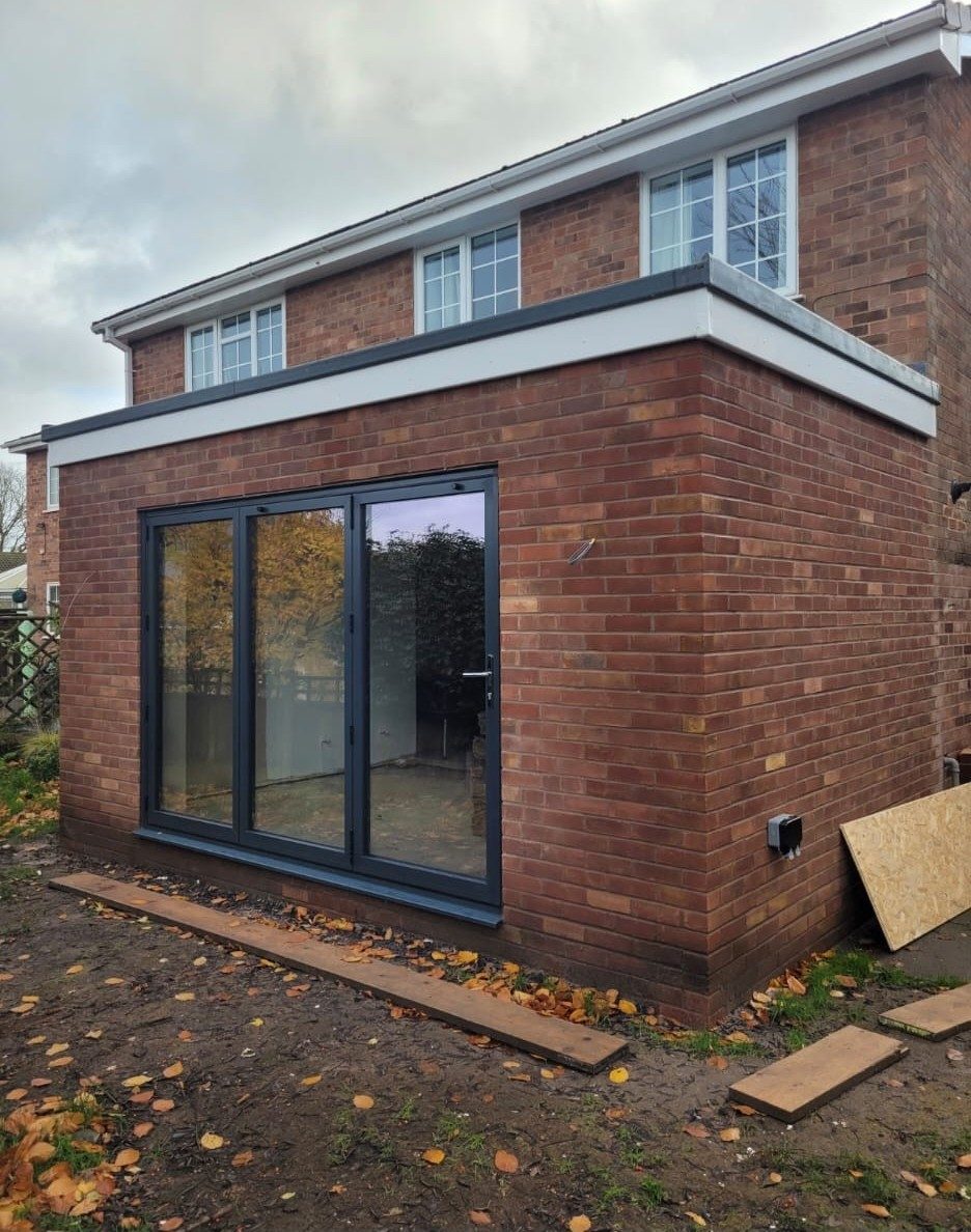 Single storey rear extension with anthracite sliding doors, Longmore Construction, Warrington