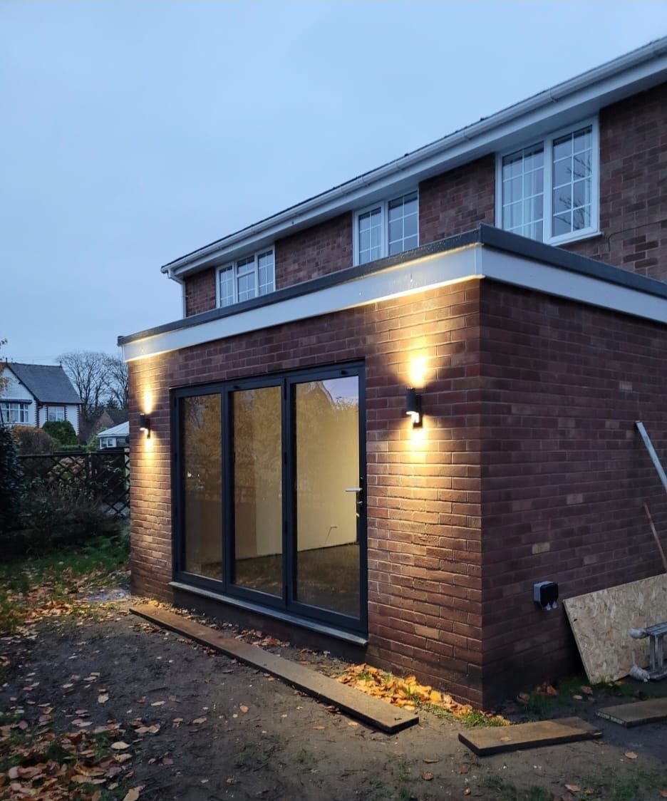 Finished rear extension at dusk with lights on