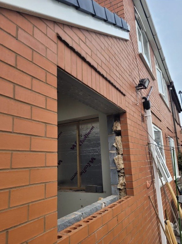 New opening formed in a brick back wall with the steel set in over it