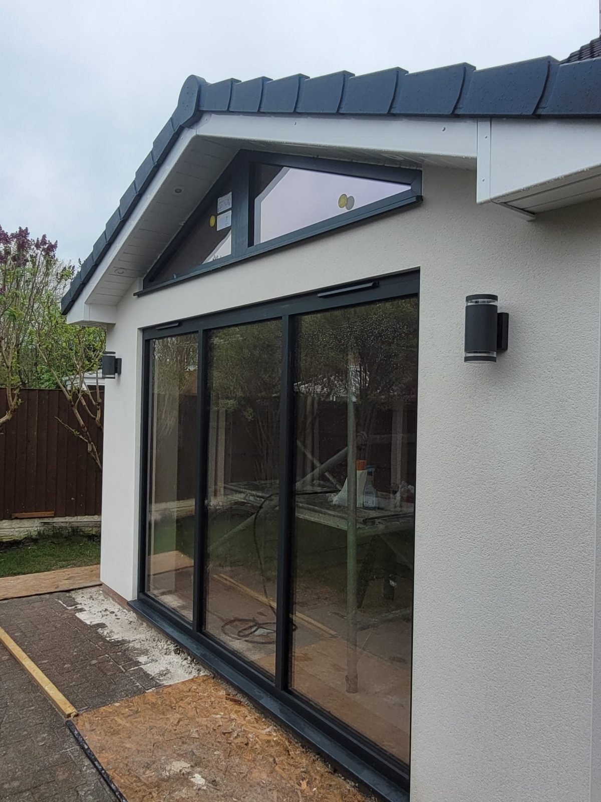 Rendered gable extension with bifold doors