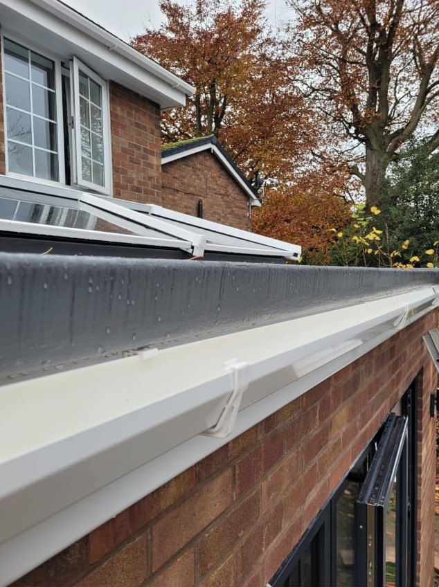 New fascia, soffit and gutter run along a finished flat roof