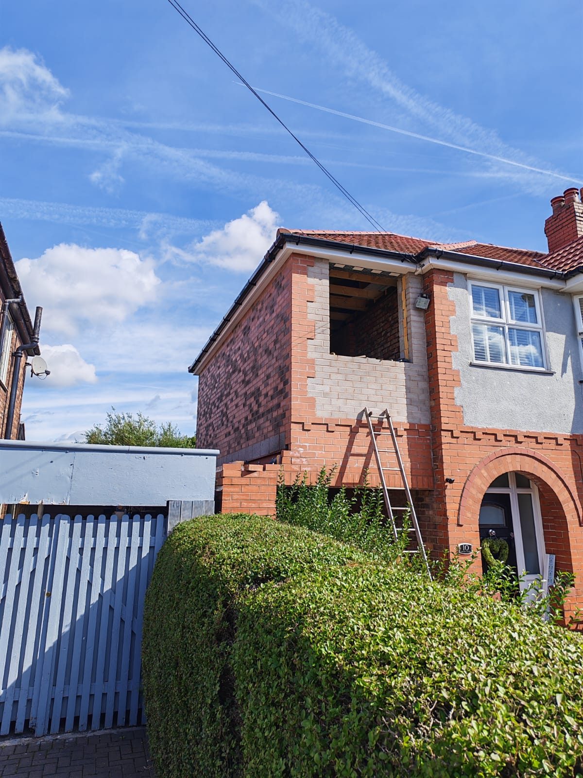 Two storey side extension part built with the window opening still open