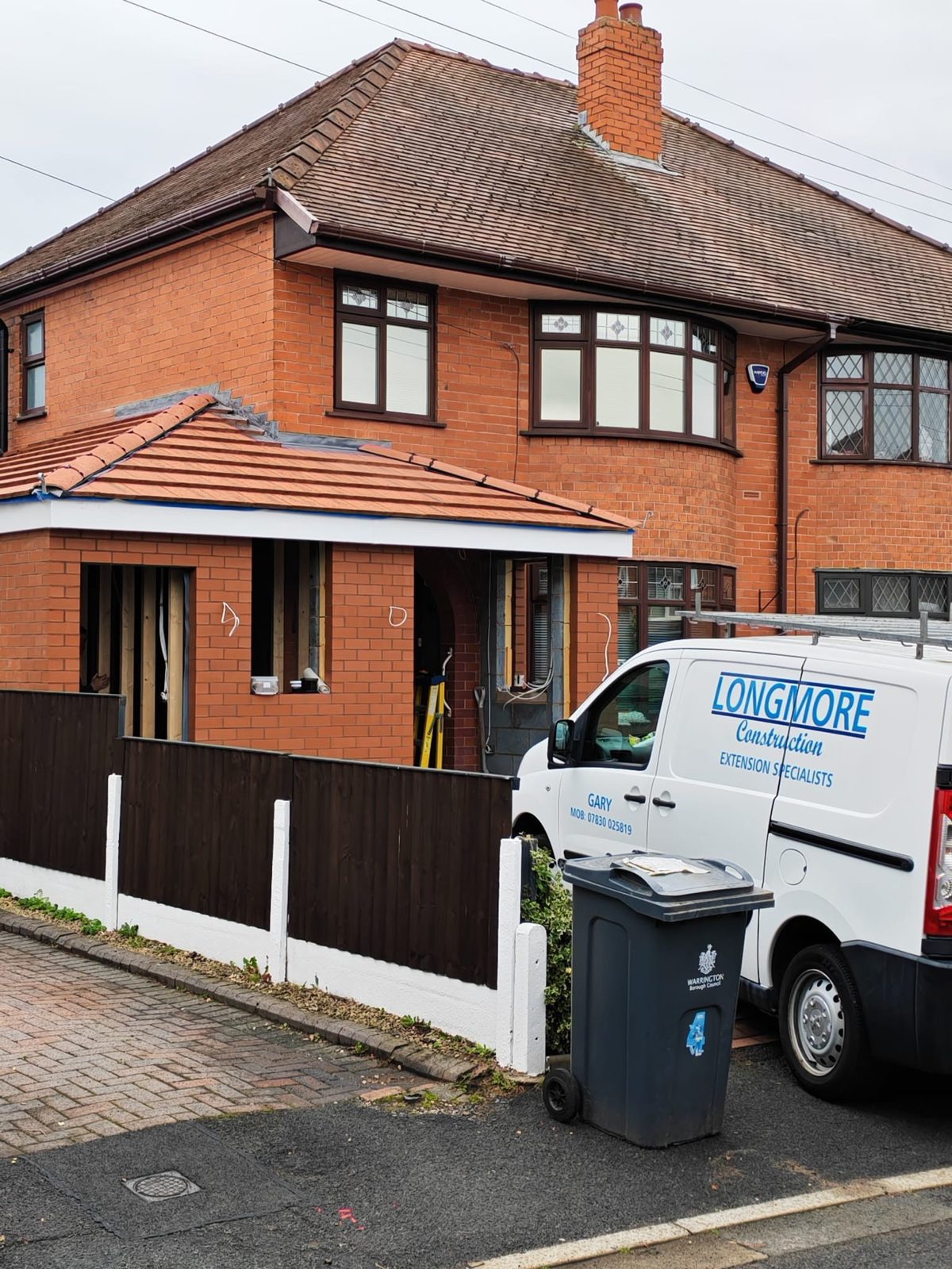 Longmore Construction van outside a job in Warrington