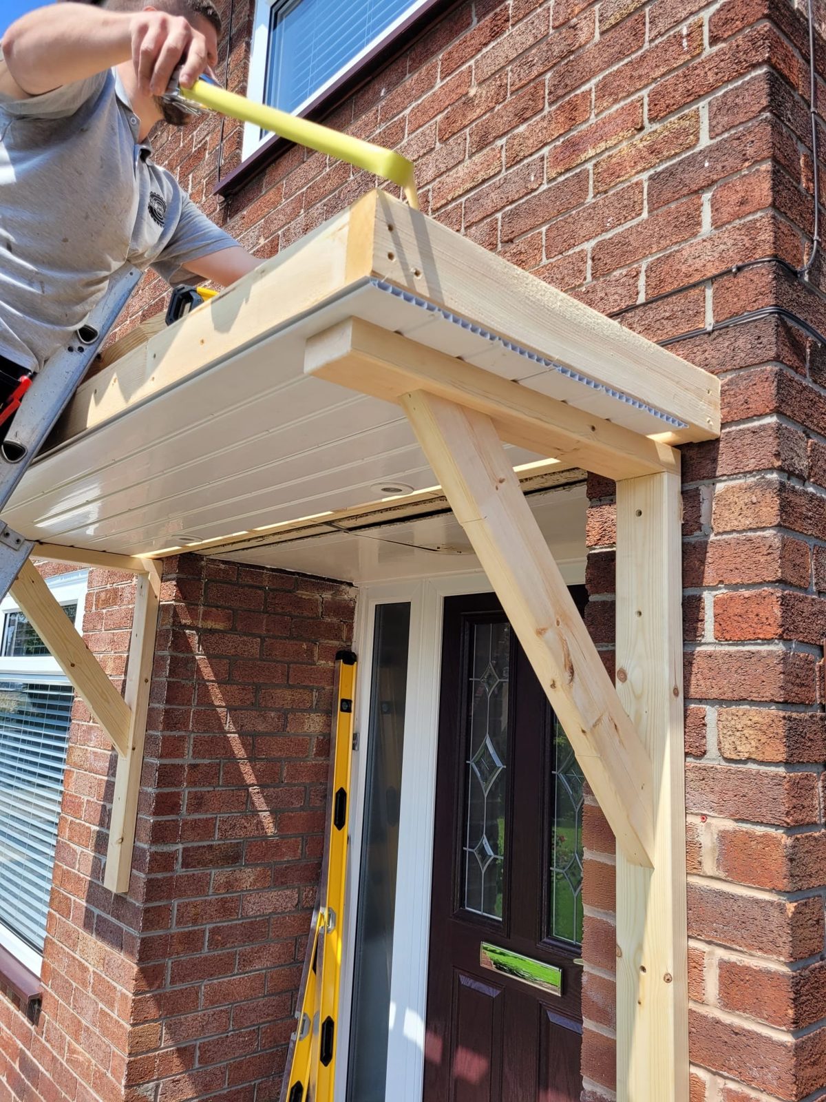 Porch canopy frame being built